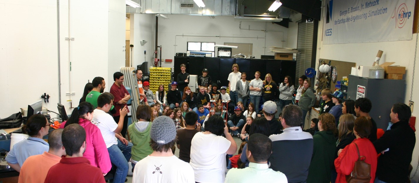 Eighth grade students and parents observe a shaking table demonstration by UC Davis graduate students in the CGM’s Clean Shop